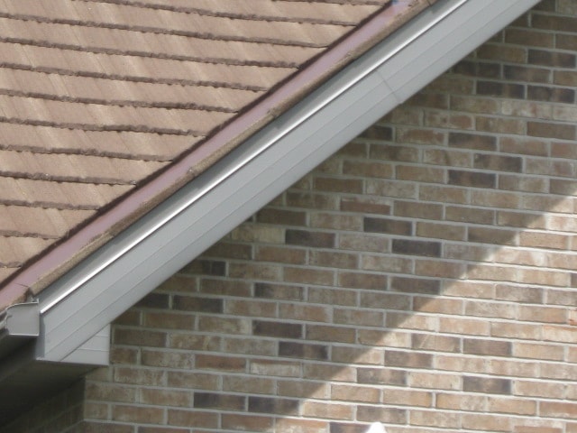 Brown Metal Shake on Brick Home — detail photo 1